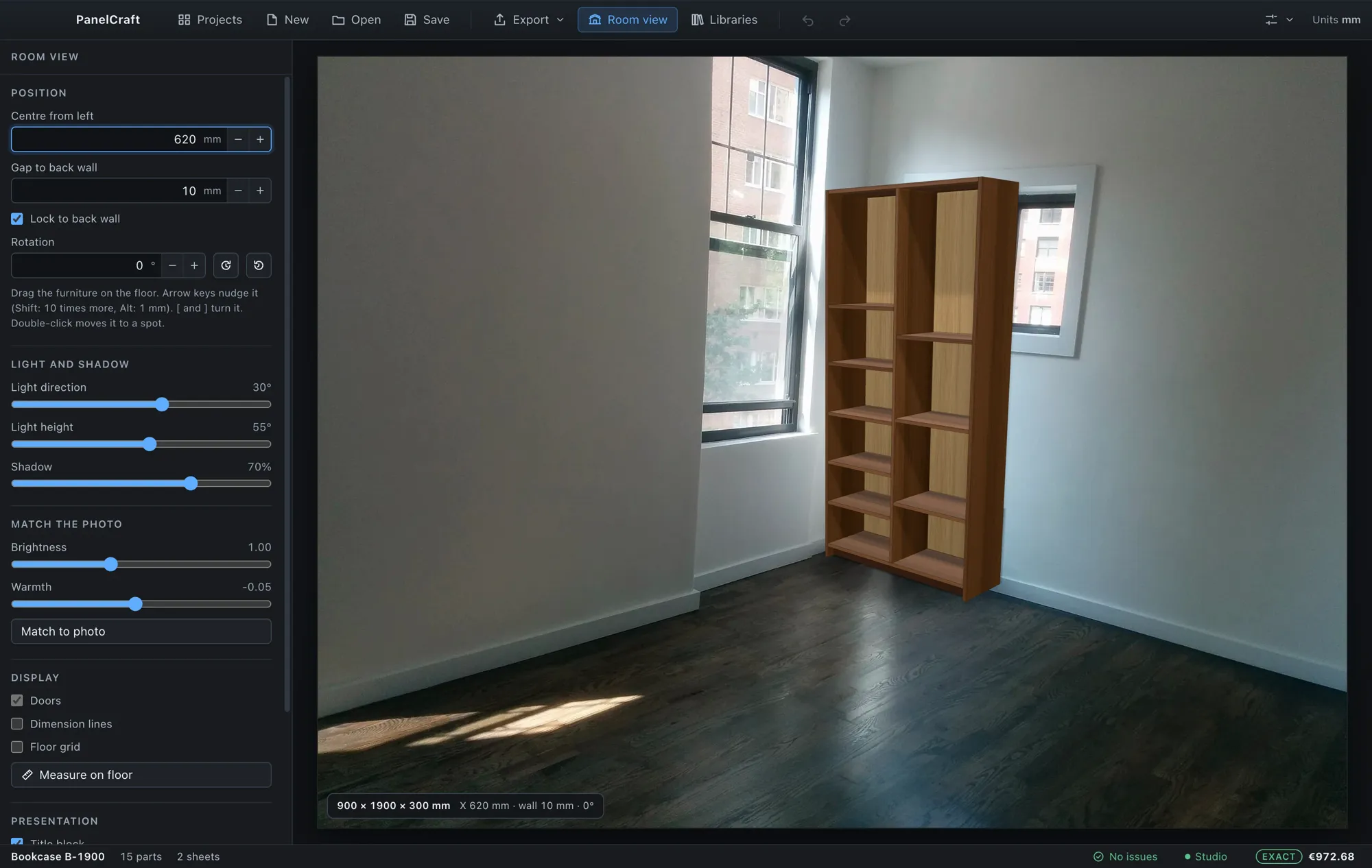 Walnut bookcase placed against the wall in a photo of an empty room.